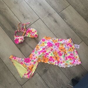 matching bikini top and bottoms, featuring a floral pattern in pink and yellow